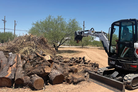 A tractor from Hercs Works removing landscaping debris in Southern Arizona